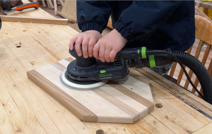 My son operating the orbital sander